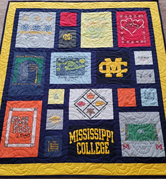 Mosaic T-shirt Quilt with Fabric in Between the T-shirt squares.