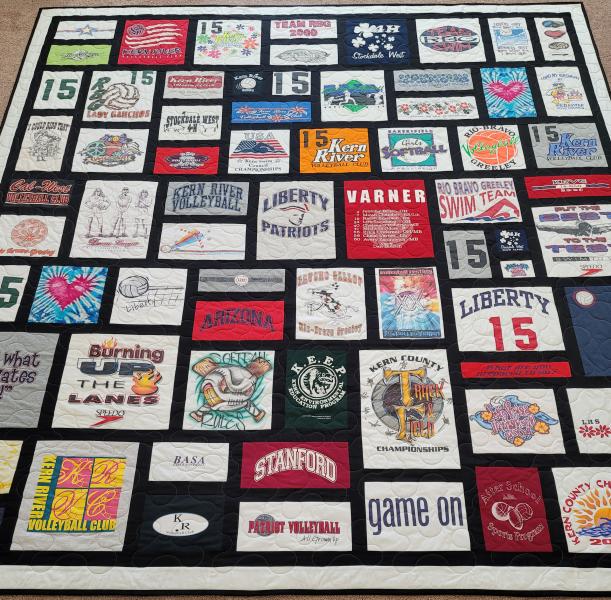 Mosaic T-shirt Quilt with Fabric in Between the T-shirt squares.