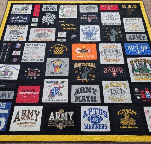 Mosaic T-shirt Quilt with Fabric in Between the T-shirt squares.