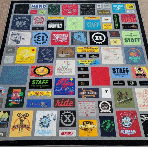 Mosaic T-shirt Quilt with Fabric in Between the T-shirt squares.