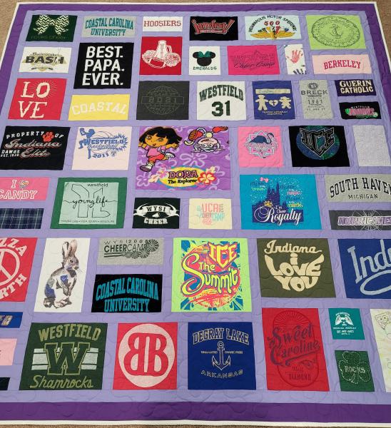 Mosaic T-shirt Quilt with Fabric in Between the T-shirt squares.