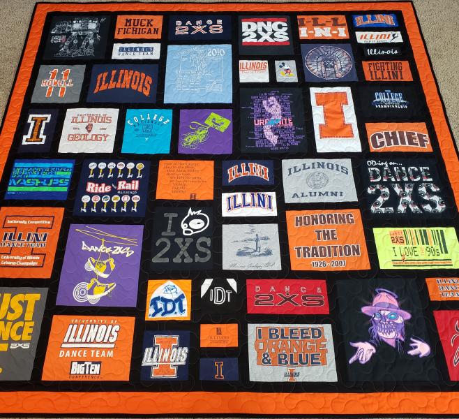 Mosaic T-shirt Quilt with Fabric in Between the T-shirt squares.