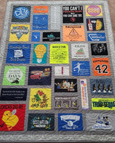 Mosaic T-shirt Quilt with Fabric in Between the T-shirt squares.