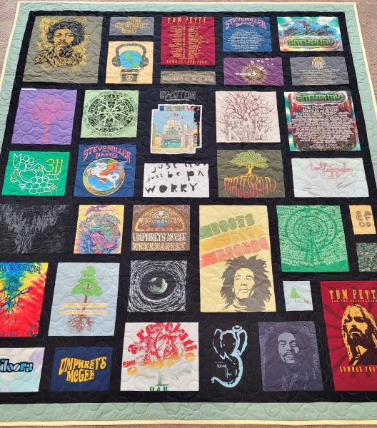 Mosaic T-shirt Quilt with Fabric in Between the T-shirt squares.