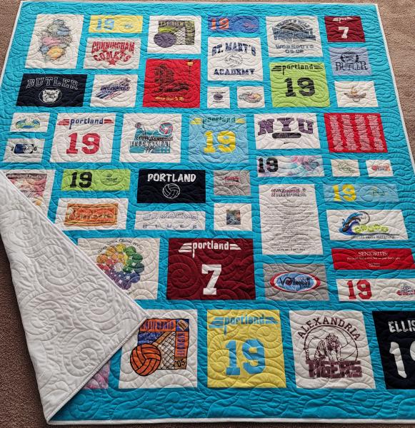 Mosaic T-shirt Quilt with Fabric in Between the T-shirt squares.