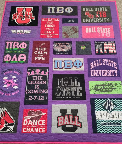 Mosaic T-shirt Quilt with Fabric in Between the T-shirt squares.