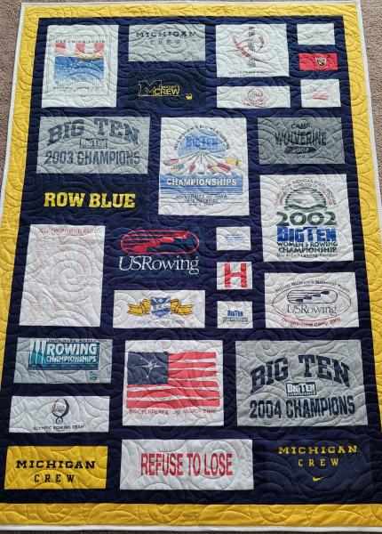 Mosaic T-shirt Quilt with Fabric in Between the T-shirt squares.