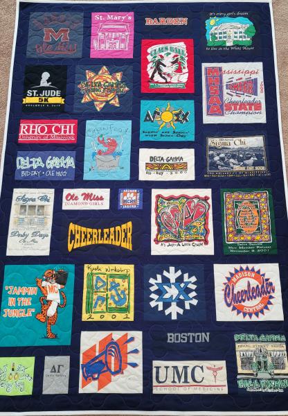 Mosaic T-shirt Quilt with Fabric in Between the T-shirt squares.