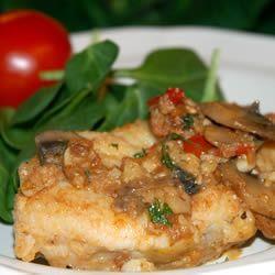 A great recipe for monkfish or tilapia with garlic, tomatoes, mushrooms, and white wine